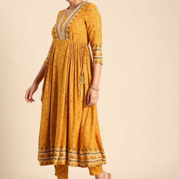 YELLOW stylish kurti pant suit set which is decorated with finest lace work on nack , side waist tassels and motifs It
